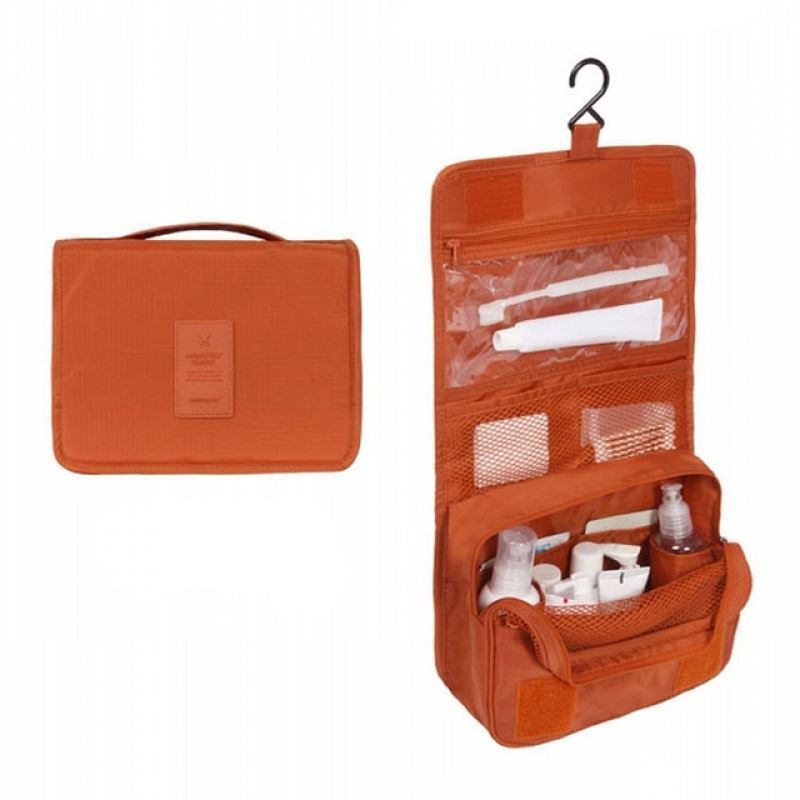 Solid Coloured Orange hanging toiletry bag. Great for travel with a large pouch with zipper, a net mesh with zipper and a clear transparent pouch with zipper, with a hook above it tp all folds into a compact bag with carry handle. hang on doors or shelving. All folds up into a neat bag with carry handle.
