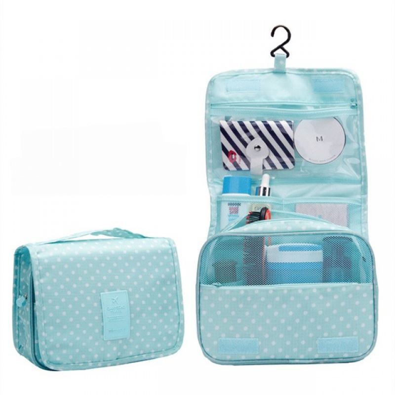 Baby Blue with white polka dots pattern hanging toiletry bag. Great for travel with a large pouch with zipper, a net mesh with zipper and a clear transparent pouch with zipper, with a hook above it tp all folds into a compact bag with carry handle. hang on doors or shelving. All folds up into a neat bag with carry handle.