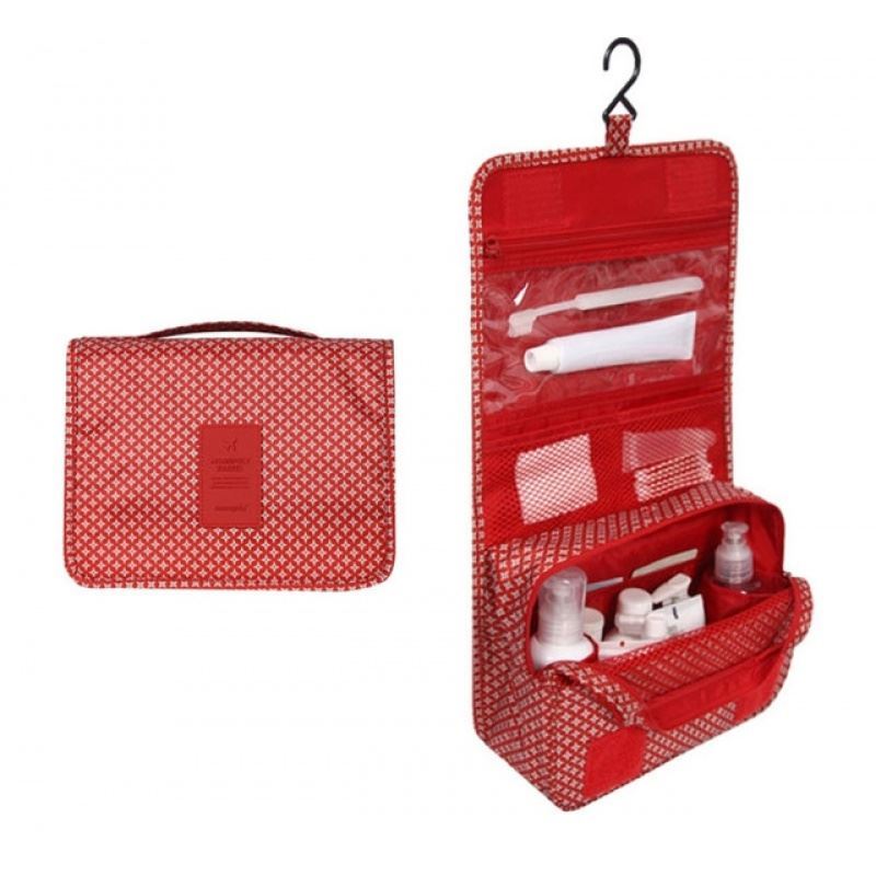Red Patterned hanging toiletry bag. the pattern is diamond shapes. Great for travel with a large pouch with zipper, a net mesh with zipper and a clear transparent pouch with zipper, with a hook above it tp all folds into a compact bag with carry handle. hang on doors or shelving. All folds up into a neat bag with carry handle.