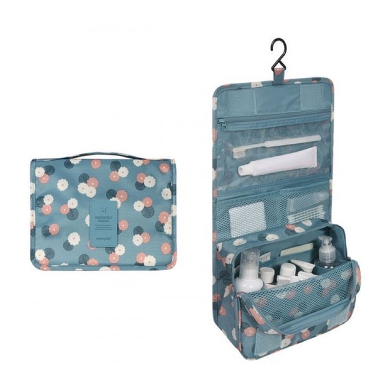 Blue and flowery pattern hanging toiletry bag. the pattern is navy, orange and white flowers on a lighter blue background. Great for travel with a large pouch with zipper, a net mesh with zipper and a clear transparent pouch with zipper, with a hook above it tp all folds into a compact bag with carry handle. hang on doors or shelving. All folds up into a neat bag with carry handle.