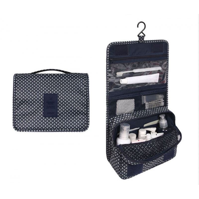 Navy Patterned hanging toiletry bag. the pattern is diamond shapes. Great for travel with a large pouch with zipper, a net mesh with zipper and a clear transparent pouch with zipper, with a hook above it tp all folds into a compact bag with carry handle. hang on doors or shelving. All folds up into a neat bag with carry handle.