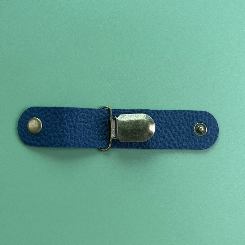This is a navy blue hat clip on a green background