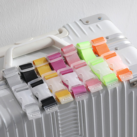 This is a white and silver carry on suitcase with the 7 different colour travel strap clips displayed across the top including the silver grey, black, yellow, pink, light pink, neon green and orange travel strap. Uses include holding bags, hats, minnie ears to suitcases or strollers.