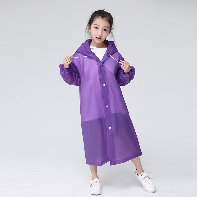 Child standing in front of a white background wearing the childrens raincoat in Purple