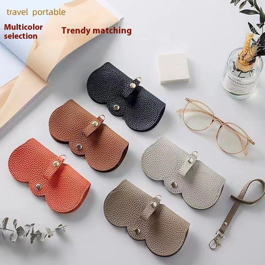flat lay of 5 of the clip on glasses holder that will clip on to your handbag, park back, suitcase carry on. Perfect for travelling too your theme park destination. The holders in this picture are black, brown, orange, grey and Khaki or dark grey. A great travel product to use for your glasses case.