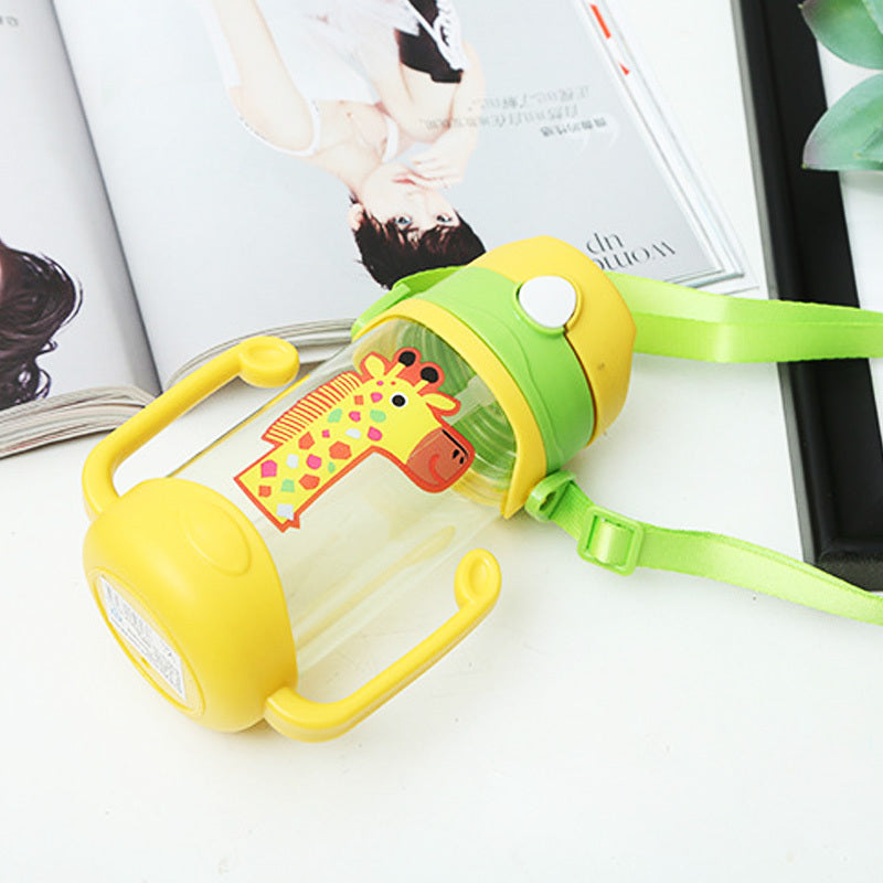 Yellow and green children's water bottle with a giraffe design on a white surface.