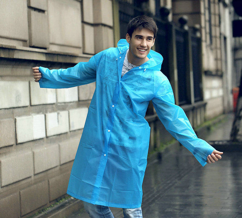 EVA Raincoat for Adults in blue. The young man is wearing the raincoat, walking down a street