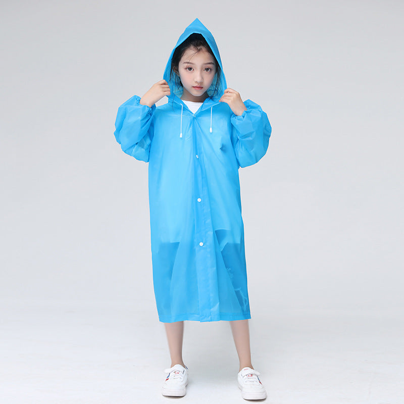 Child standing in front of a white background wearing the childrens raincoat in blue
