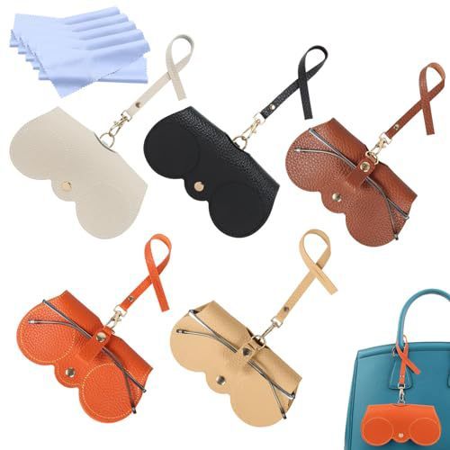 a white flat lay of 5 of the clip on glasses or sunglasses holder in beige, orange, grey, black and brown. The orange clip on sunglasses holder is also being demonstrated on a blue handbag handle. A great travel product to use for your glasses case.