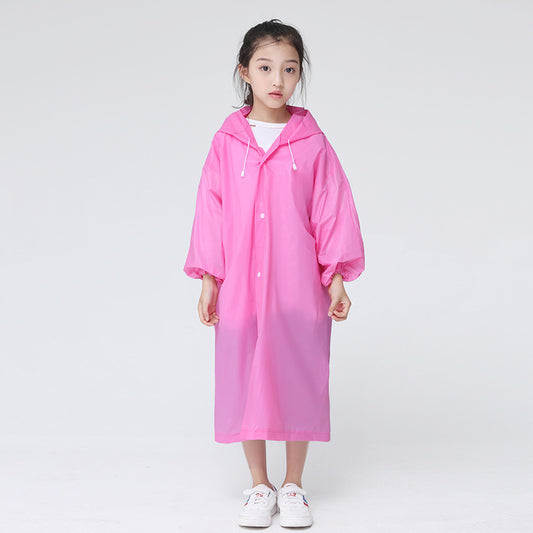 Child standing in front of a white background wearing the childrens raincoat in pink