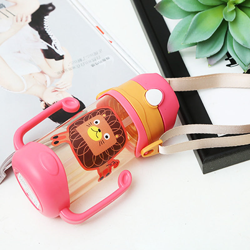 Pink and beige children's water bottle with lion design on a white surface