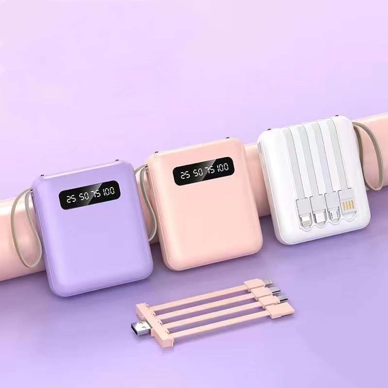 This picture shows the purple, white and pink charger with the cables in front of them