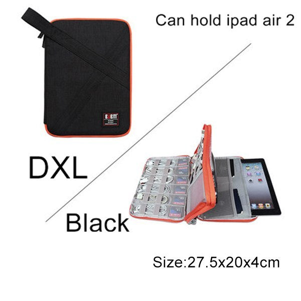 DXL black Cable Organiser bag for travel. it is rectangular with a orange zipper. it has multiple bands for cables on 2 sides and there is an extra pouch with pockets that fits phones or tablet.