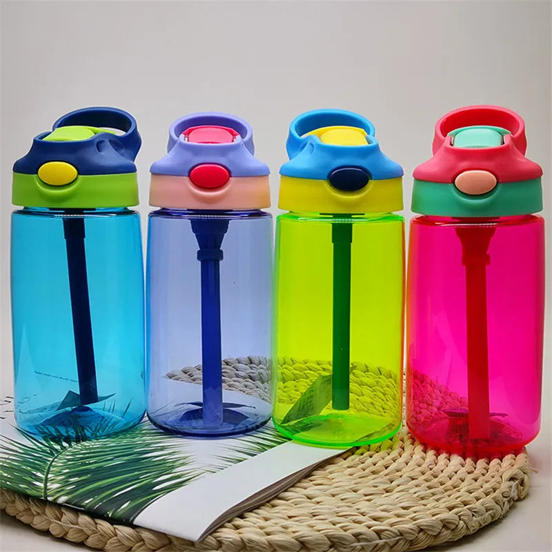 this photo shows the 4 kids water bottles stood together on a straw place mat.