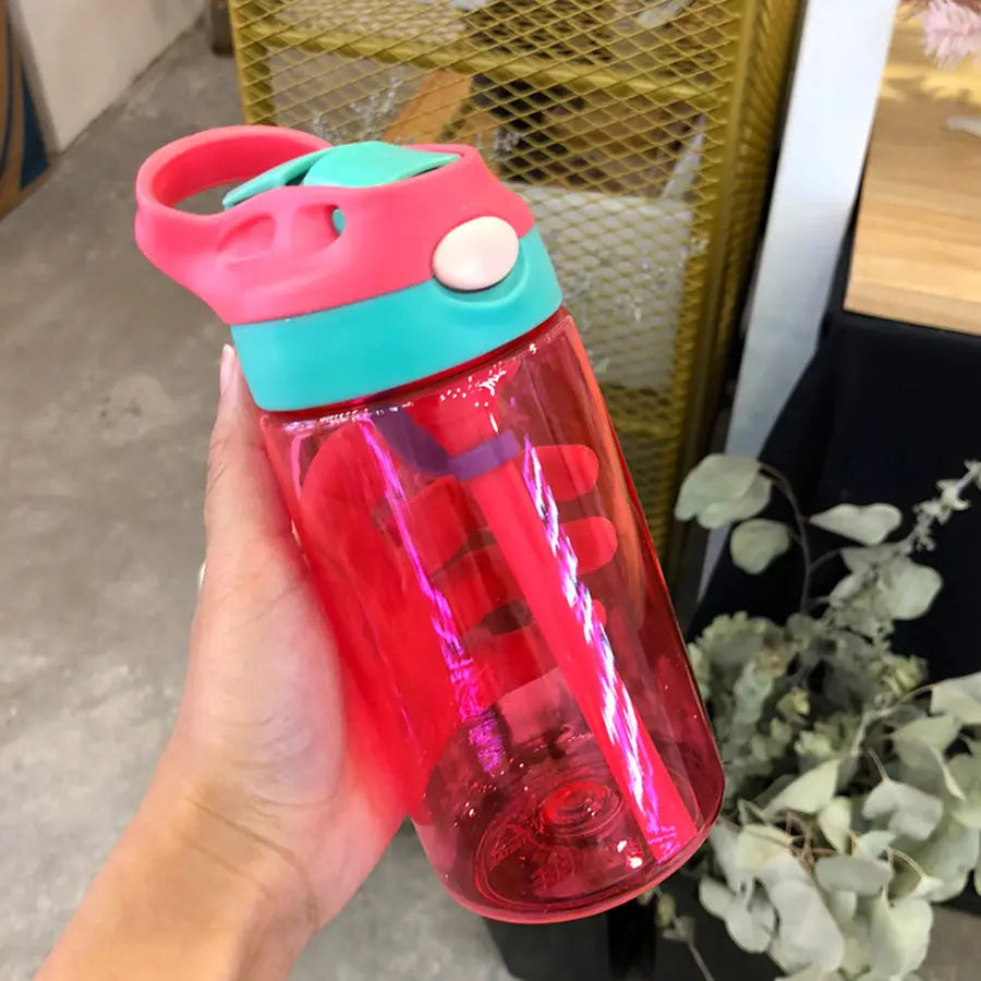 this is the red kids water bottle with straw the lid has a green band at the bottem, the handle is red matching the cup. the straw enclosure is green and the flip button is cream.