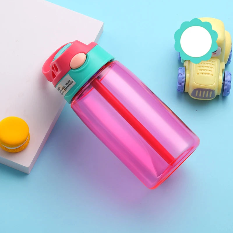 this is the red kids water bottle with straw the lid has a green band at the bottem, the handle is red matching the cup. the straw enclosure is green and the flip button is cream.