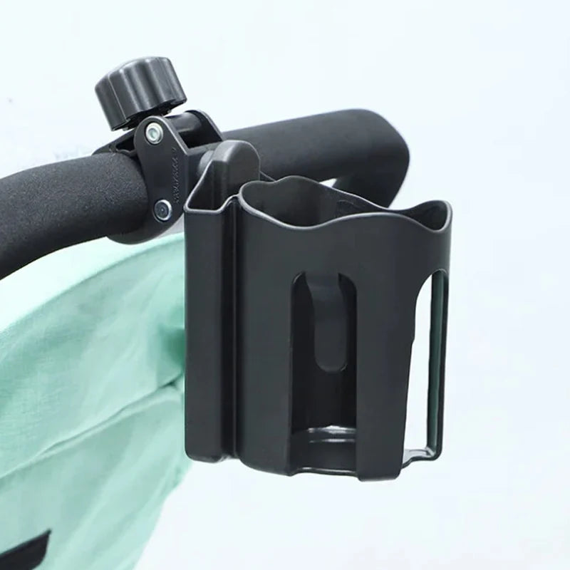 Black stroller cup holder attached to a stroller handle on a light blue background