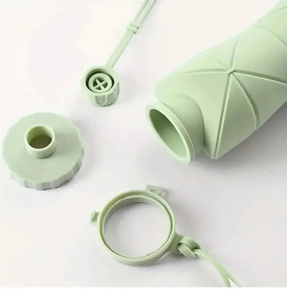 this image shows the bottle componants. the bottle, the collar which has the band to hold the bottle together when its folded. the mouth piece and the mouth piece cover.