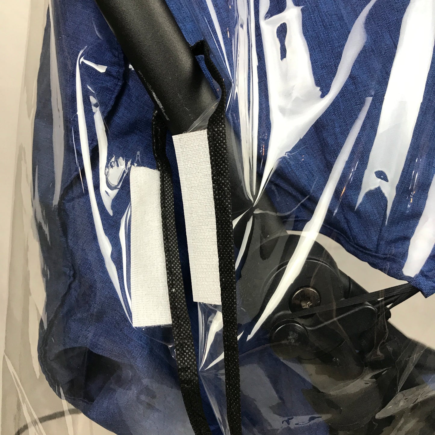 Close-up of a the black lined rain cover with velcro closures