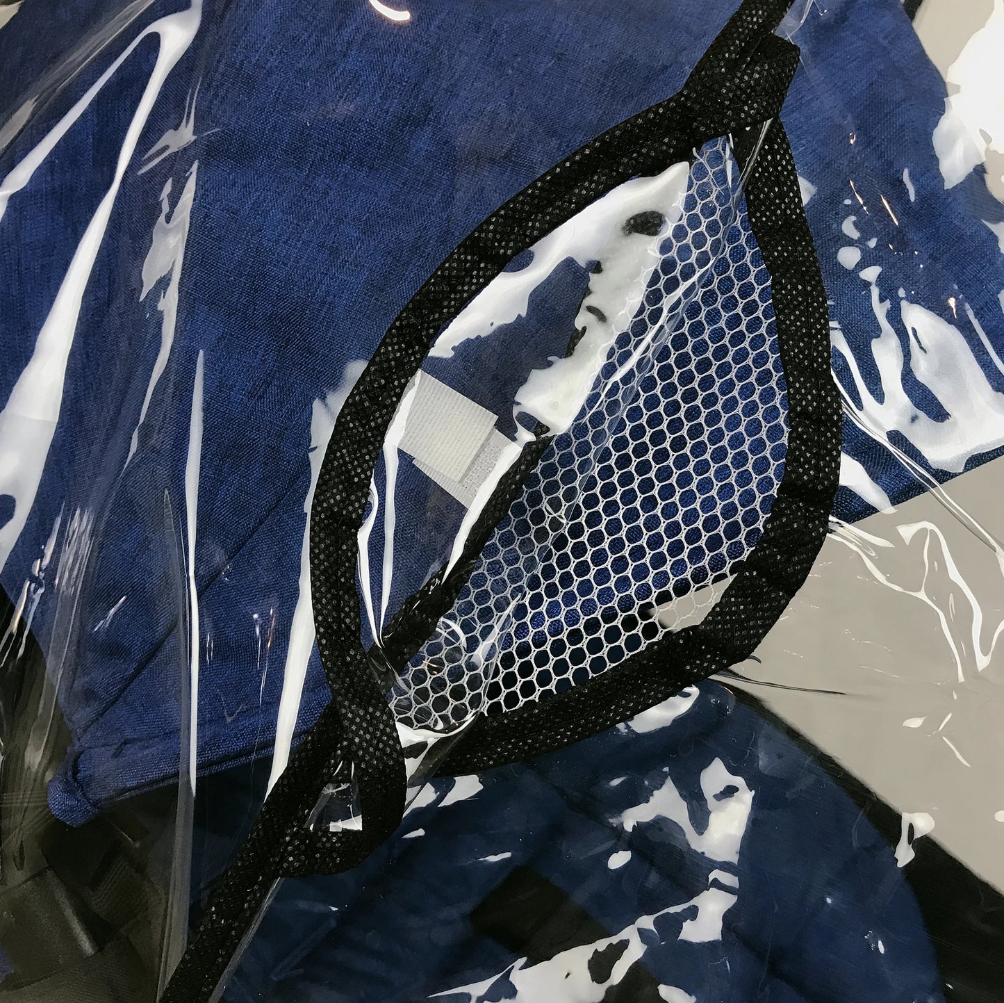 Close-up of a black lined mesh pocket on a white background