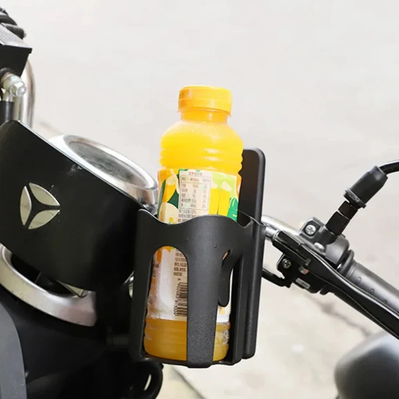 Bottle holder on a motorcycle with a bottle of orange juice inside