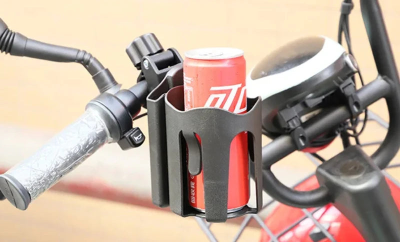 Bicycle handlebar with a drink holder holding a can of pop against a beige background