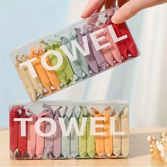 Packaged colorful towels with 'Towel' text on a light background