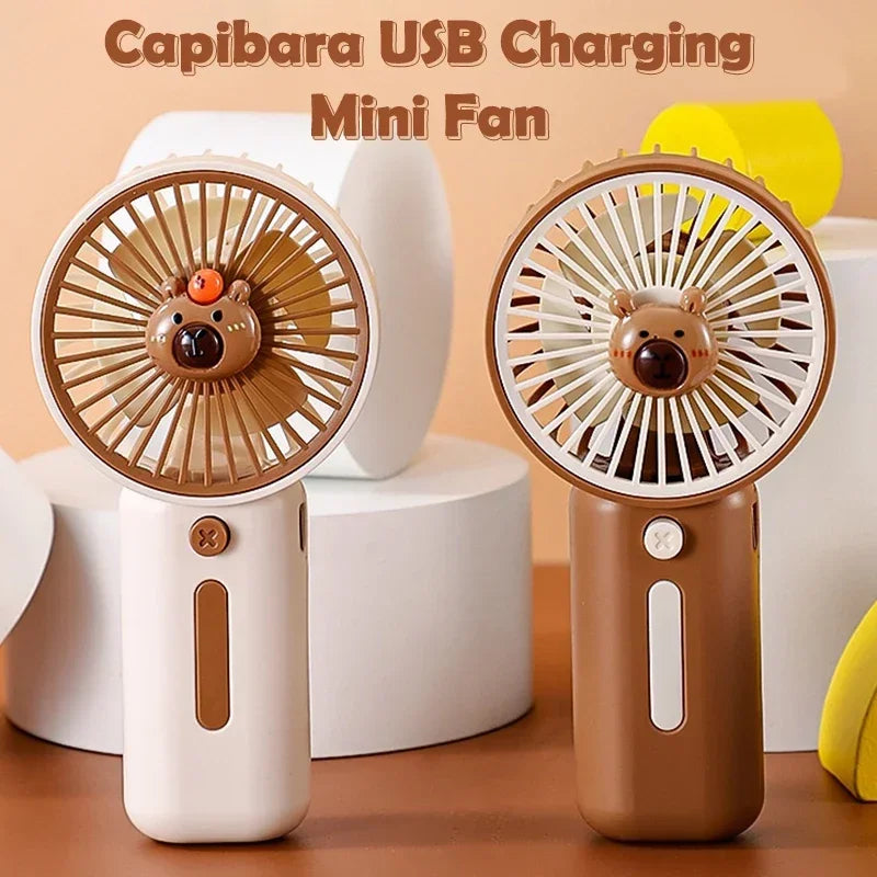 Compact Capybara-themed handheld USB fan one is white the other brown
– perfect for travel or theme park use