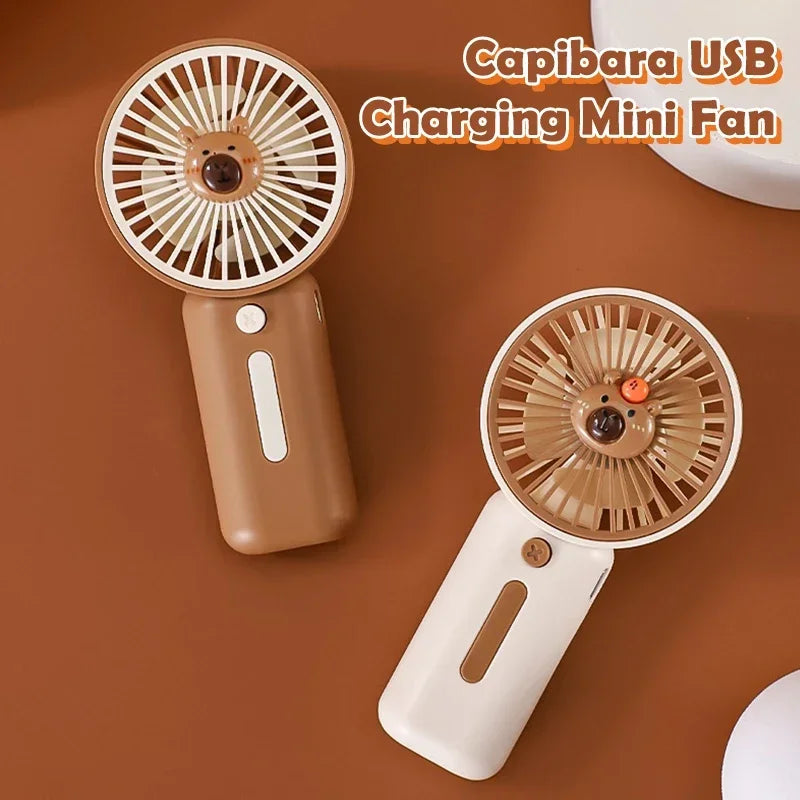 Compact Capybara-themed handheld USB fan one is white the other brown
– perfect for travel or theme park use