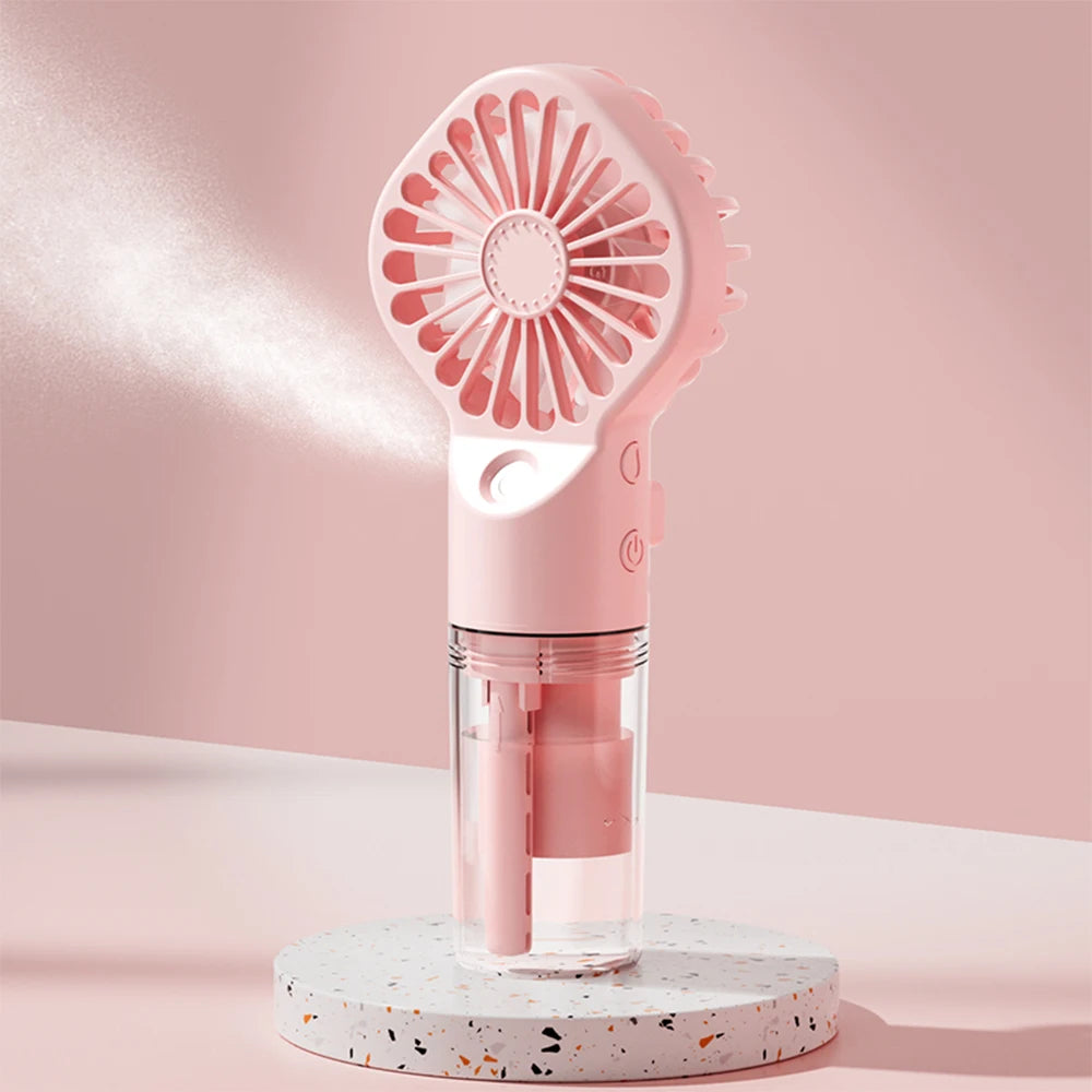 Pink handheld fan on a light pink background