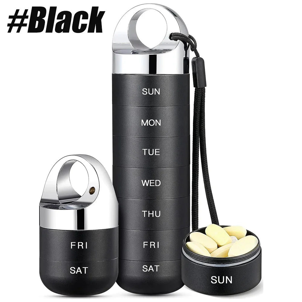 Black pill organizer with compartments for each day of the week, featuring silver lids.