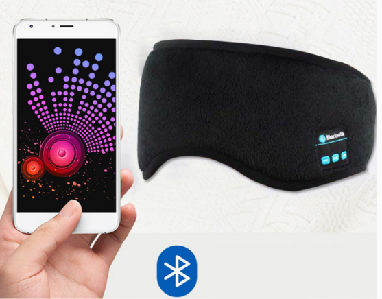 Black Bluetooth sleep mask with smartphone displaying music app on a white background