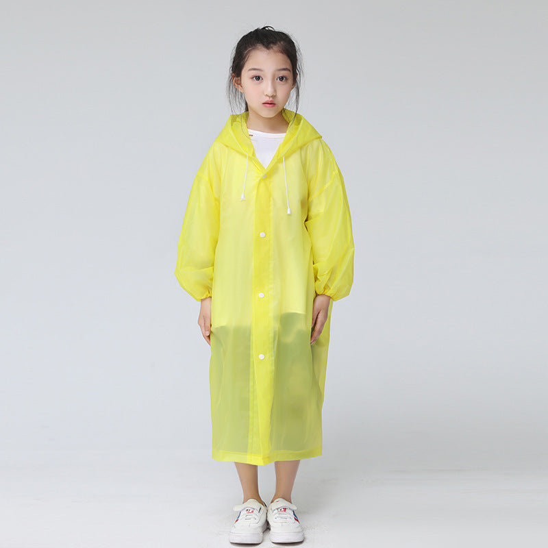 Child standing in front of a white background wearing the childrens raincoat in yellow