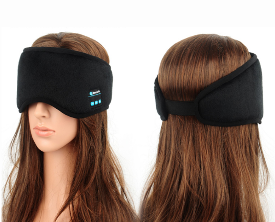 Black Bluetooth sleep mask on a mannequin head showing velcro adjustment band at the back