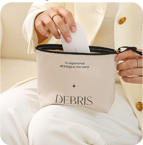 This shows a lady putting a glasses case into the sundry bag. The Word Debris with a star above it and the words to experience all things in the world. Which is a nice reminder that however we experience the world we should try everything.