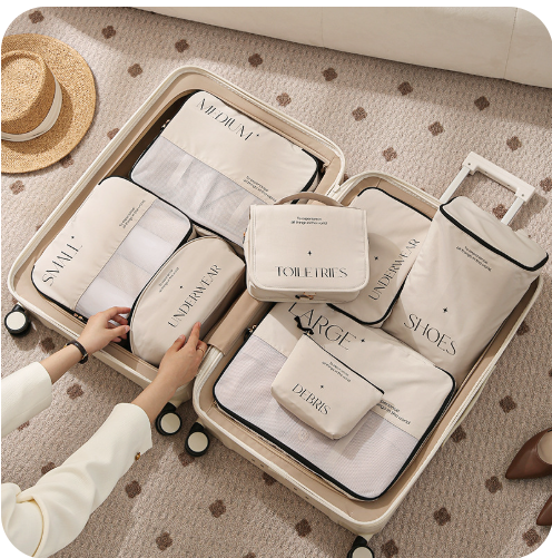 This shows and open suitcase with the 8 piece set of packing cubes. this beige/cream set with black writing on is an aesthetically pleasing set of packing cubes. This set includes clothing storage bag in small, medium and large, toiletries bag with hook, underwear bag, shoe bag and sundry bag which can be used for gadgets, cables or make up.