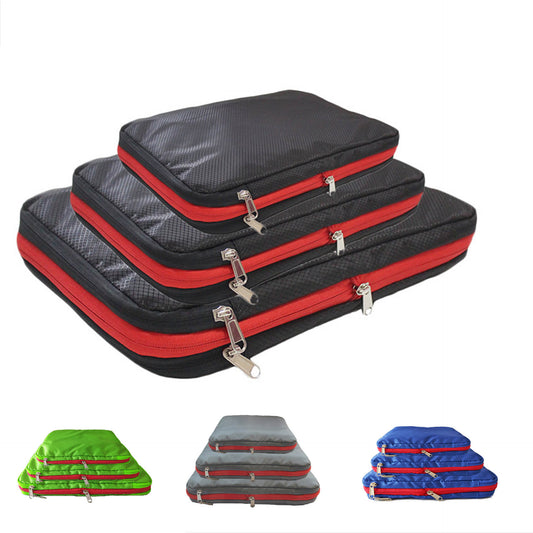 A set of 3 Compression Packing Cubes stacked on top of each other in small, medium and large. They are black with red zipper, and rectangular shaped