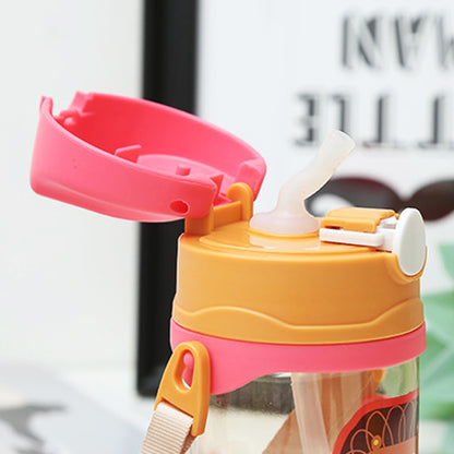 Colorful water bottle with pink and orange lid and straw on a blurred background