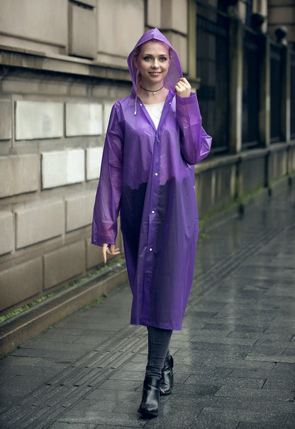 EVA Raincoat for Adults in Purple. The young woman is wearing the raincoat, walking down the street
