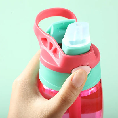 This image shows a close up of the straw and a thumb on the push button, you can also see the sturdy cup handle