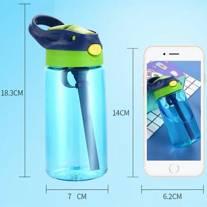 This image is of the blue bottle and showing that its size is slightly taller and wider than an smart phone. the bottle from base to the top of the handle is 18.3cm and the base of the kids water bottle is 7 cm