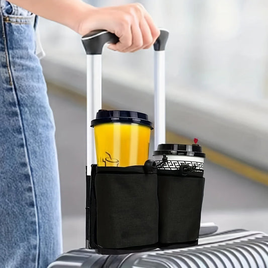 Person holding a luggage handle with a cup holder containing two coffee cups.