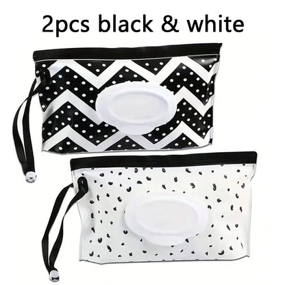 2 piece set black & White tissue holders. one is white with black spots, the other is black with white spots and zig zags