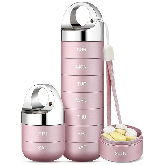 Pink pill organizer with silver lids on a white background
