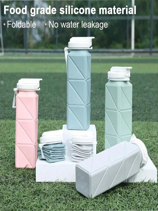 Collapsible water bottles in various colors on grass with text about food-grade silicone material.