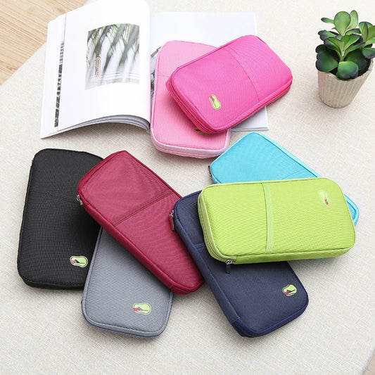 This shows all the colourful travel wallets on the floor. Pink, rose pink, blue, green, navy, wine red, grey and black