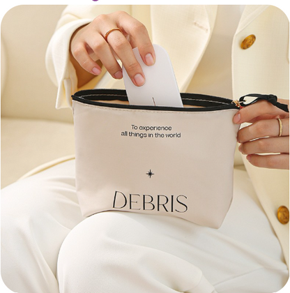 This shows a lady putting a glasses case into the sundry bag. The Word Debris with a star above it and the words to experience all things in the world. Which is a nice reminder that however we experience the world we should try everything.